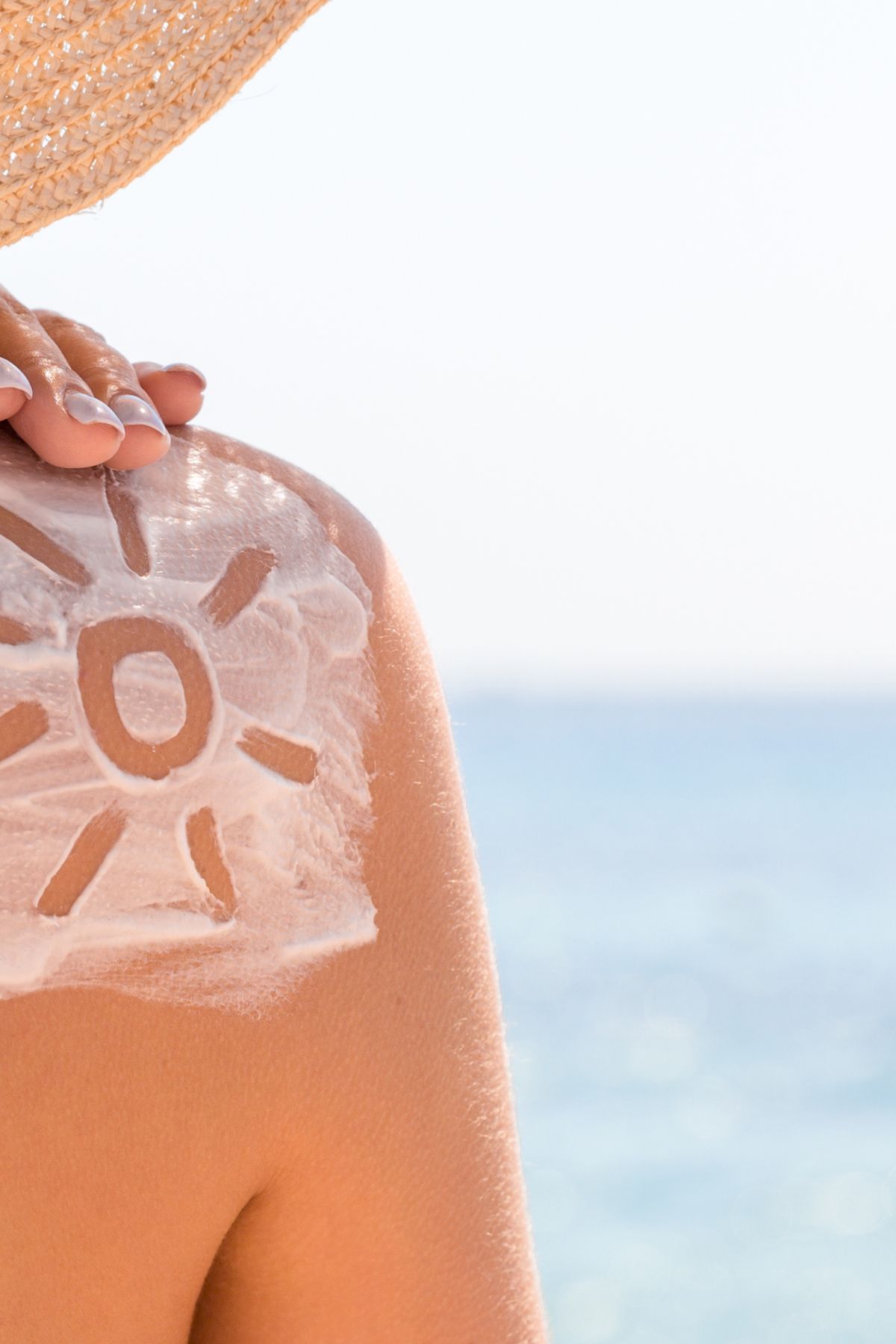 sunscreen on woman's shoulder