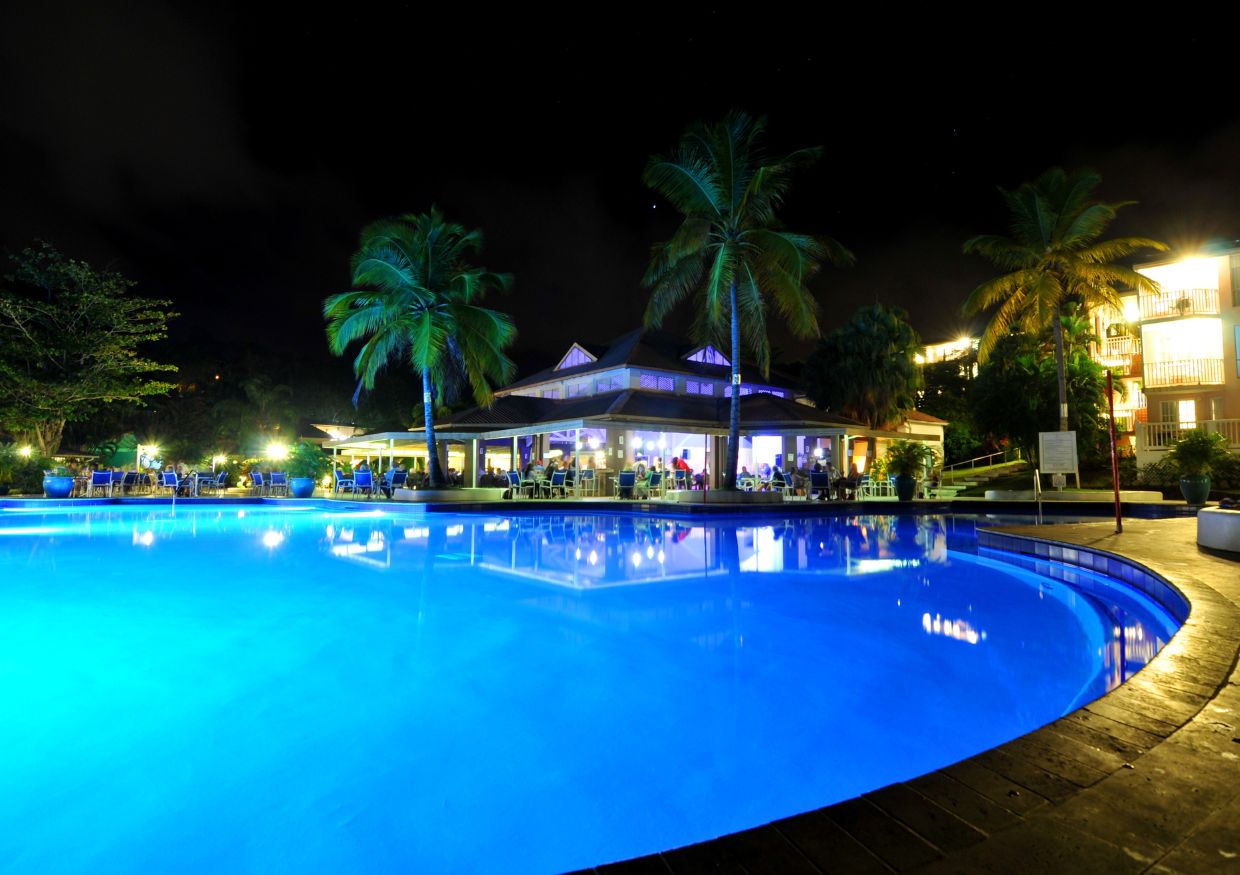 The pool at the all-inclusive resort in St. Lucia is lit up at night.