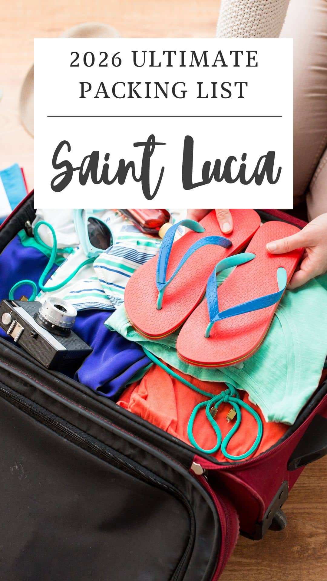 Open suitcase packed with clothes, flip flops, camera, and accessories, with text overlay: "2026 Ultimate Packing List for your St Lucia vacation.