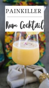 A glass of Painkiller rum cocktail with a straw and pineapple slice garnish. Colorful background with text above: "Painkiller Rum Cocktail.