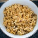 A bowl of shredded dried fish is placed on a dark surface.
